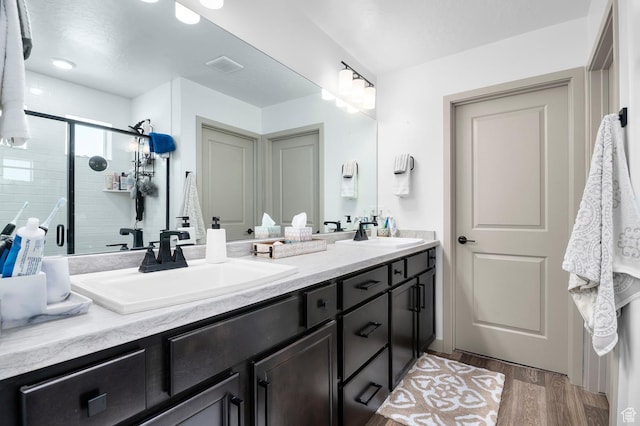 106 E Polaris Dr, Saratoga Springs, UT 84045 - bathroom featuring double vanity, wood finished floors, and a stall shower
