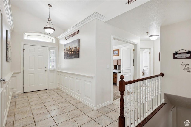 3634 N 225 E, North Ogden, UT 84414 - foyer entrance with light tile patterned floors, wainscoting, a decorative wall, and lofted ceiling