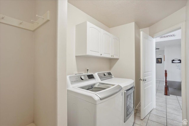 3634 N 225 E, North Ogden, UT 84414 - laundry area featuring washer and clothes dryer, cabinet space, light tile patterned flooring, and a textured ceiling