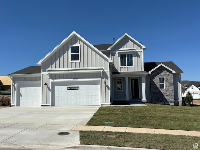 1678 S 130 W Unit 48, Salem, UT 84653 - view of front facade with board and batten siding, a front lawn, driveway, and stone siding