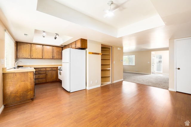 330 E Peach Ln, Bountiful, UT 84010 - kitchen with freestanding refrigerator, brown cabinets, a raised ceiling, and open floor plan