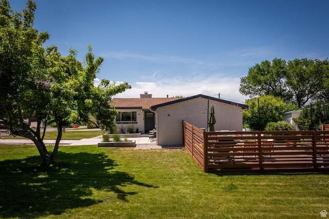 68 W 3600 S, Bountiful, UT 84010 - back of house with a yard, a chimney, and brick siding