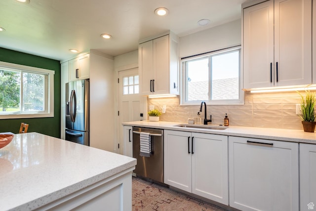 68 W 3600 S, Bountiful, UT 84010 - kitchen featuring appliances with stainless steel finishes, healthy amount of natural light, recessed lighting, decorative backsplash, and white cabinetry