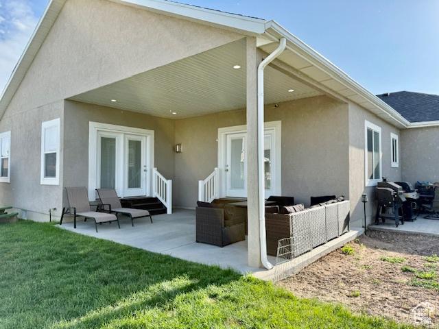 4026 S 3700 W, West Haven, UT 84401 - back of house featuring stucco siding, a patio area, an outdoor hangout area, and a yard