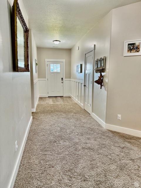 4026 S 3700 W, West Haven, UT 84401 - entryway featuring carpet, a textured ceiling, and wainscoting