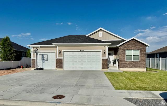 4026 S 3700 W, West Haven, UT 84401 - view of front of house with a garage, driveway, and brick siding