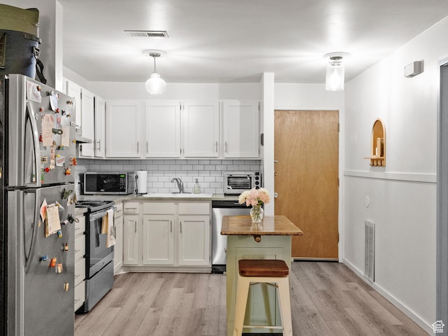 425 S 1000 E Unit 402C, Salt Lake City, UT 84102 - kitchen featuring appliances with stainless steel finishes, decorative backsplash, and white cabinetry