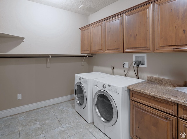 3903 S 3200 W, West Valley City, UT 84119 - laundry room with cabinet space, washer and dryer, a textured ceiling, and light tile patterned floors
