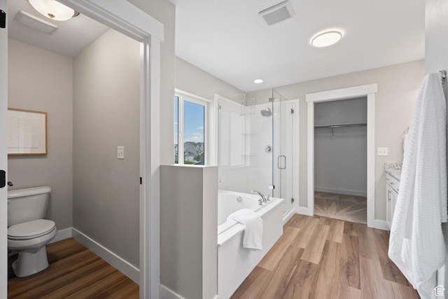3256 S Iron Hill Cir, Saratoga Springs, UT 84045 - full bath featuring a stall shower, a walk in closet, a bath, and wood finished floors