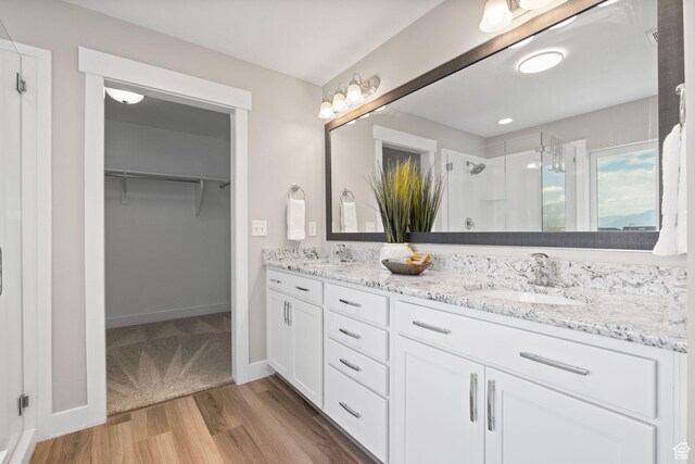 3256 S Iron Hill Cir, Saratoga Springs, UT 84045 - full bathroom with a shower stall, double vanity, a spacious closet, and wood finished floors