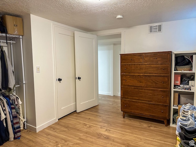 3269 Liberty Ave, Ogden, UT 84403 - bedroom featuring light wood-type flooring and a textured ceiling