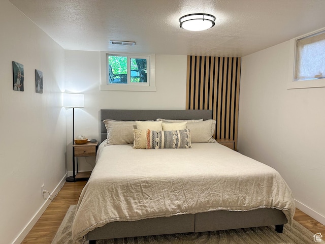 3269 Liberty Ave, Ogden, UT 84403 - bedroom featuring a textured ceiling and wood finished floors