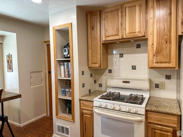 3269 Liberty Ave, Ogden, UT 84403 - kitchen with white gas stove, backsplash, wood finished floors, a textured ceiling, and light stone countertops