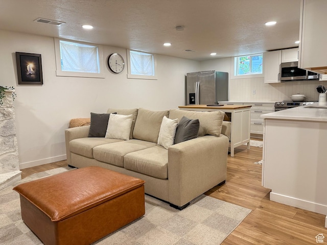3269 Liberty Ave, Ogden, UT 84403 - living area with recessed lighting and light wood finished floors