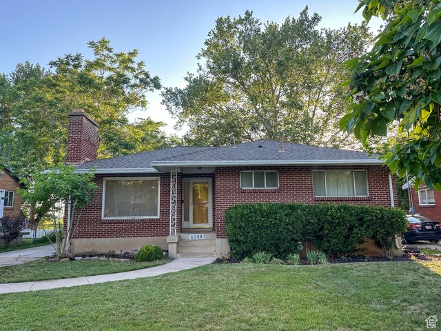 3269 Liberty Ave, Ogden, UT 84403 - single story home featuring brick siding, a front lawn, a chimney, and a shingled roof
