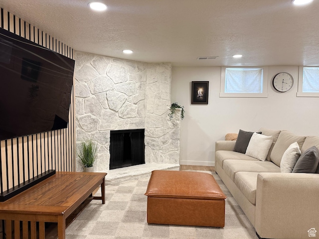 3269 Liberty Ave, Ogden, UT 84403 - living room with recessed lighting, a textured ceiling, carpet floors, and a stone fireplace