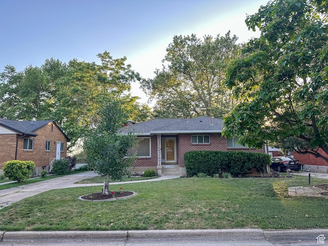 3269 Liberty Ave, Ogden, UT 84403 - ranch-style home with a front lawn, brick siding, and concrete driveway