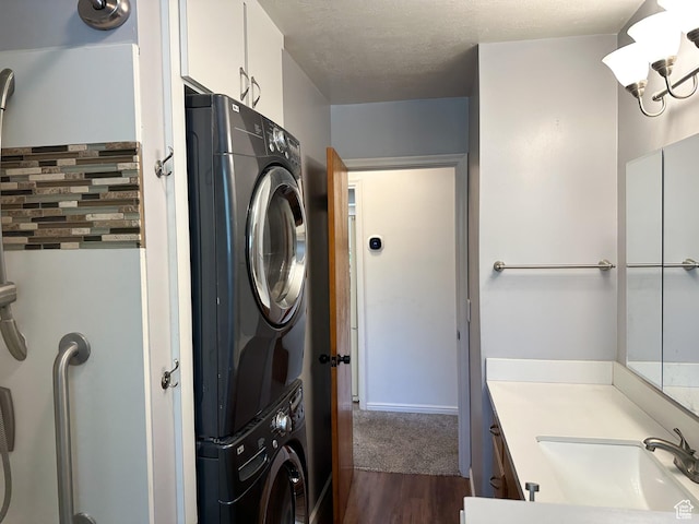 3269 Liberty Ave, Ogden, UT 84403 - bathroom featuring stacked washer / dryer, wood finished floors, vanity, and a textured ceiling