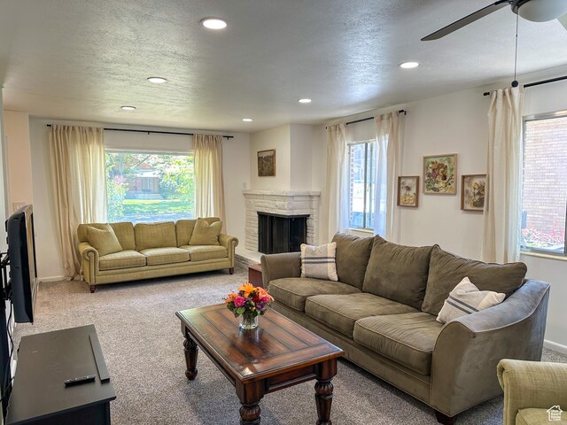 3269 Liberty Ave, Ogden, UT 84403 - carpeted living area with plenty of natural light, recessed lighting, ceiling fan, a stone fireplace, and a textured ceiling