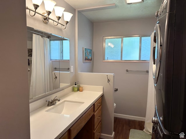 3269 Liberty Ave, Ogden, UT 84403 - full bathroom with vanity, wood finished floors, and a shower with shower curtain