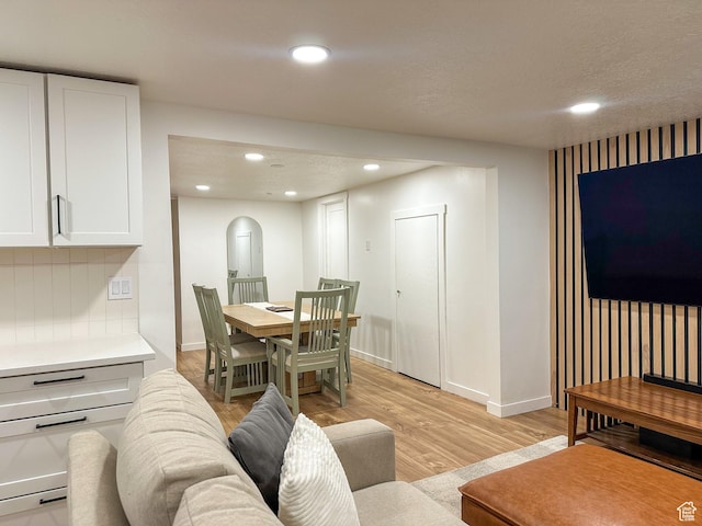 3269 Liberty Ave, Ogden, UT 84403 - living room with light wood-type flooring, arched walkways, and recessed lighting