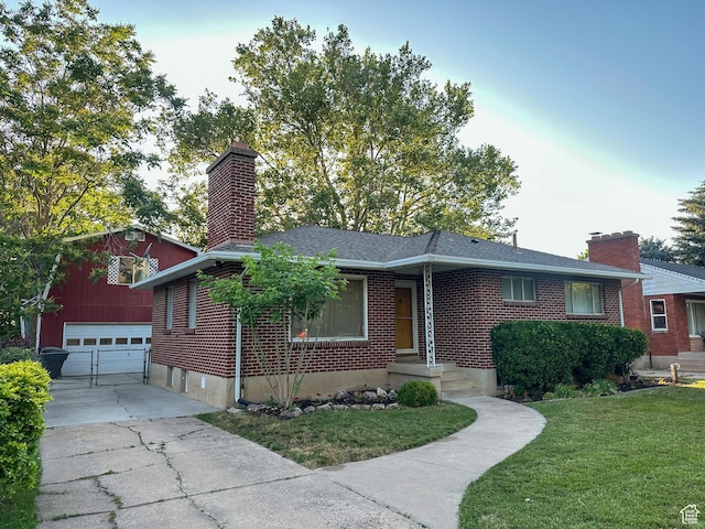 3269 Liberty Ave, Ogden, UT 84403 - ranch-style house featuring a chimney, a garage, an outdoor structure, brick siding, and a front lawn