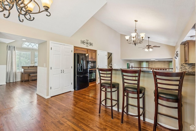 1087 W Barnes Dr, Kaysville, UT 84037 - kitchen featuring black appliances, a chandelier, vaulted ceiling, dark wood-style floors, and dark countertops