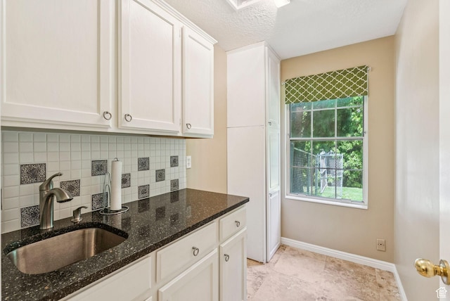1087 W Barnes Dr, Kaysville, UT 84037 - kitchen with backsplash, white cabinetry, dark stone counters, and a textured ceiling