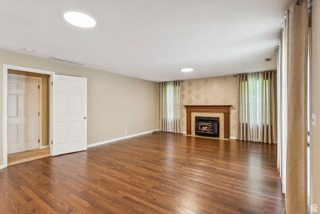 1087 W Barnes Dr, Kaysville, UT 84037 - unfurnished living room with wood finished floors, a fireplace with flush hearth, and a textured ceiling