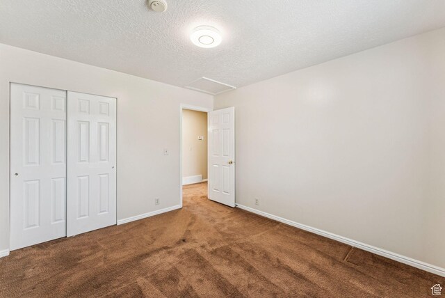1087 W Barnes Dr, Kaysville, UT 84037 - unfurnished bedroom featuring carpet floors, a closet, attic access, and a textured ceiling