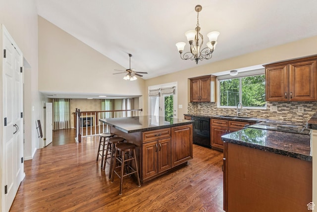 1087 W Barnes Dr, Kaysville, UT 84037 - kitchen featuring black dishwasher, backsplash, dark wood-type flooring, a kitchen bar, and a chandelier