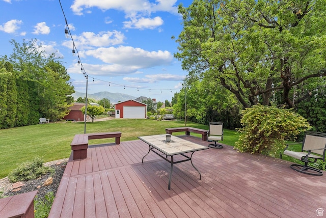 1087 W Barnes Dr, Kaysville, UT 84037 - wooden terrace with a lawn, a mountain view, an outdoor structure, and a detached garage