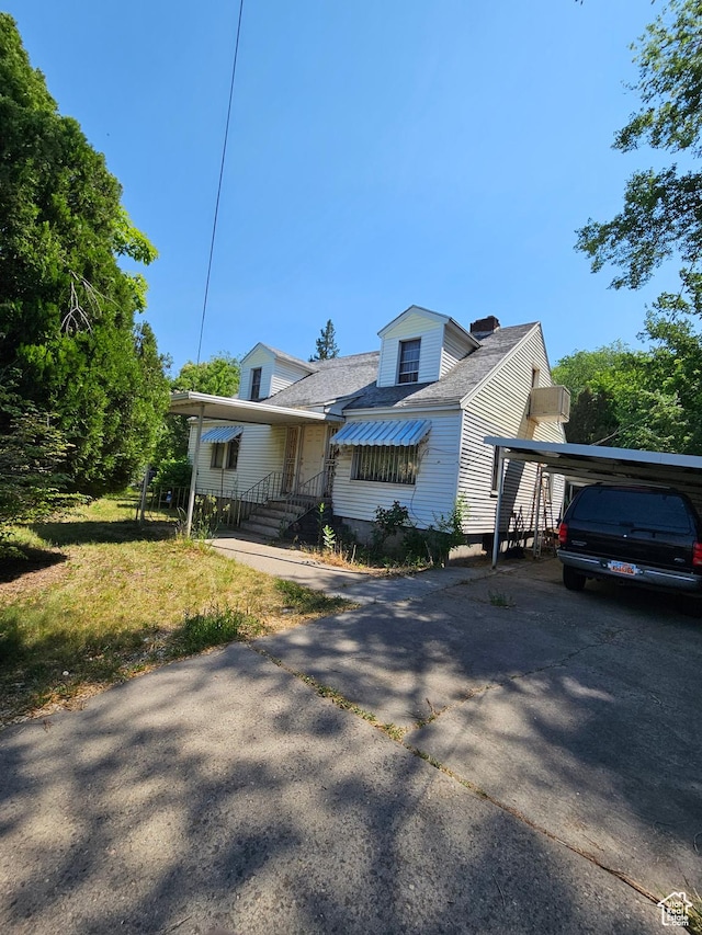110 S Wall Ave E, Ogden, UT 84404 - view of front of property featuring concrete driveway, a carport, roof with shingles, and a chimney