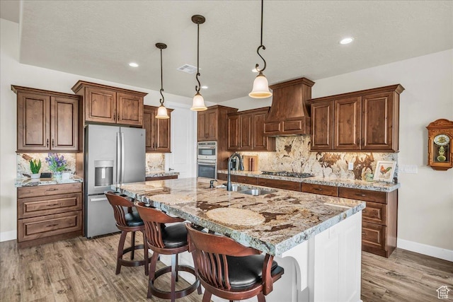 1472 W Pocket Mesa Dr, St George, UT 84770 - kitchen with stainless steel appliances, premium range hood, light wood-style flooring, backsplash, and recessed lighting