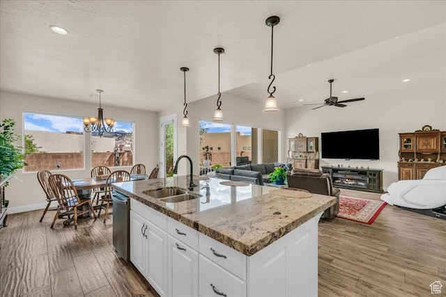 1472 W Pocket Mesa Dr, St George, UT 84770 - kitchen with healthy amount of natural light, a center island with sink, white cabinets, a chandelier, and recessed lighting