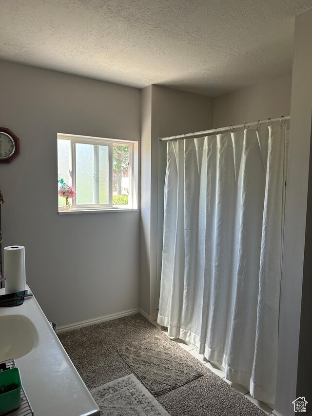 225 N 200 W, Tooele, UT 84074 - full bathroom featuring a textured ceiling, vanity, and curtained shower