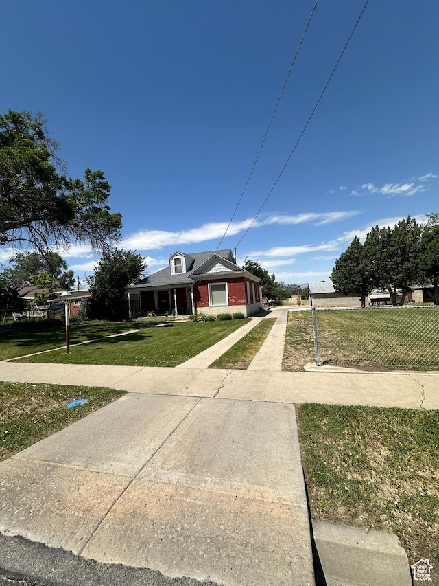 225 N 200 W, Tooele, UT 84074 - view of front of home featuring a front lawn, brick siding, and driveway