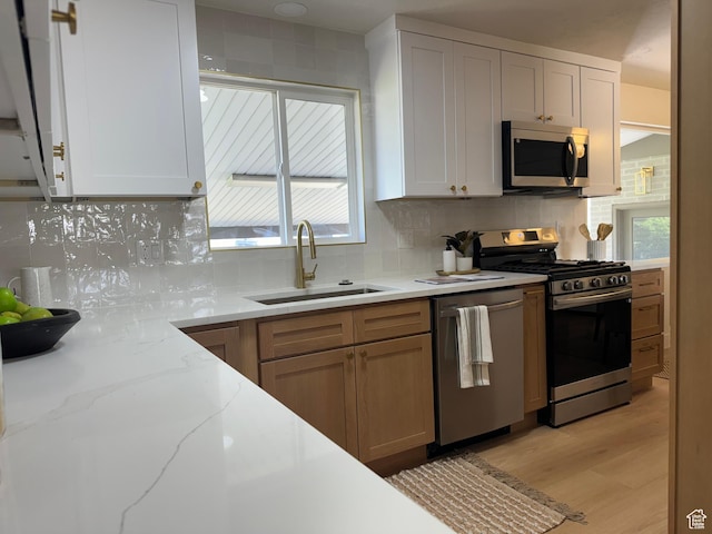 1371 E Skyview Dr, Millcreek, UT 84124 - kitchen with stainless steel appliances, backsplash, and light stone countertops