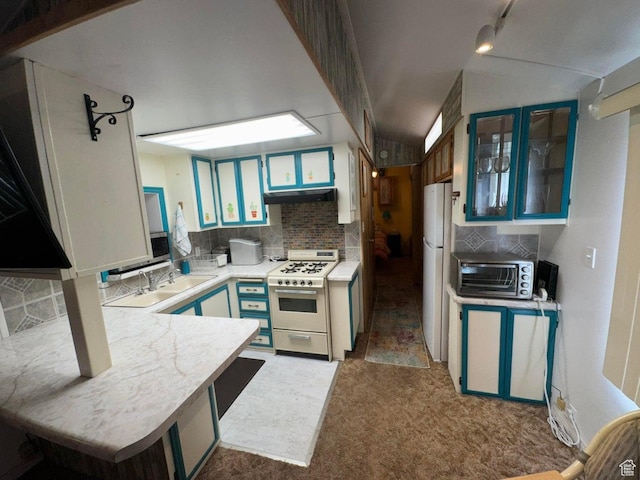 1225 N Dixie Downs Rd Unit 100, St George, UT 84770 - kitchen with white appliances, under cabinet range hood, light countertops, decorative backsplash, and carpet flooring