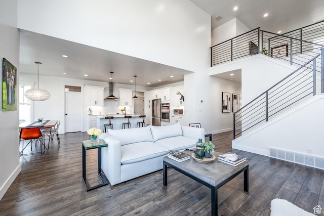 2452 E Lone Hill Dr Unit 324, Draper Ut Cnty, UT 84020 - living area with dark wood-type flooring, stairway, recessed lighting, and a towering ceiling