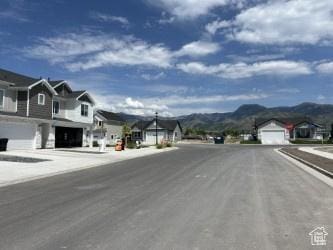 669 W 575 N Unit 552, Smithfield, UT 84335 - view of asphalt road with a residential view, a mountain view, street lights, and sidewalks