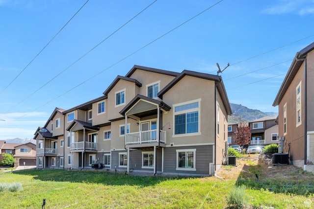 766 S Aspen Cir, Provo, UT 84606 - rear view of house with stucco siding, a yard, and a balcony