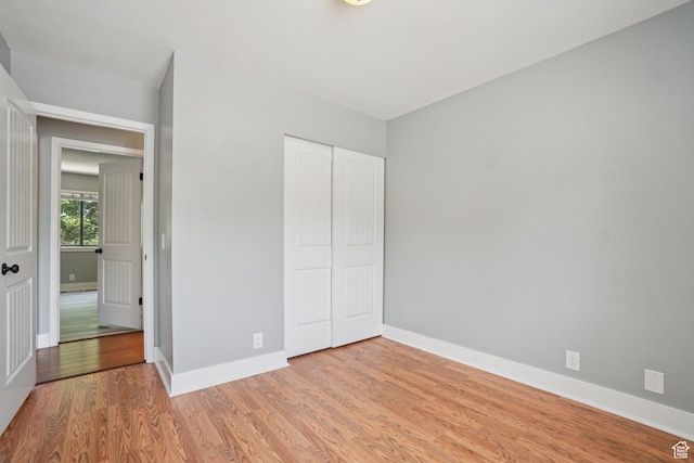 8892 S Flatiron Dr, Sandy, UT 84093 - unfurnished bedroom featuring light wood-type flooring and a closet