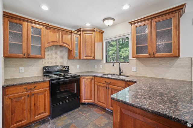8892 S Flatiron Dr, Sandy, UT 84093 - kitchen with black electric range, brown cabinetry, glass insert cabinets, and recessed lighting
