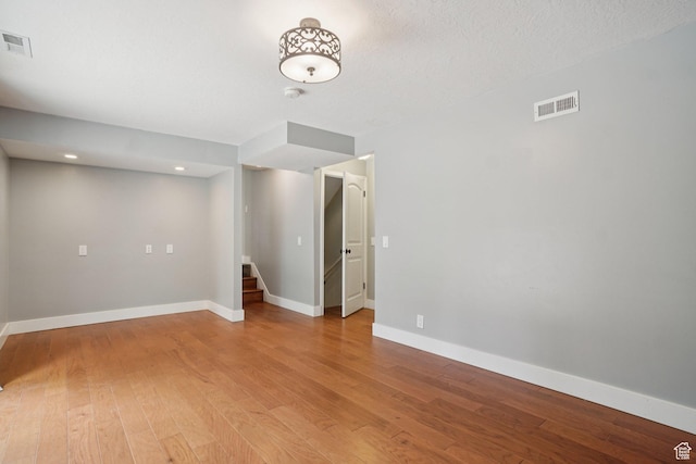 8892 S Flatiron Dr, Sandy, UT 84093 - empty room with light wood finished floors, stairway, and recessed lighting