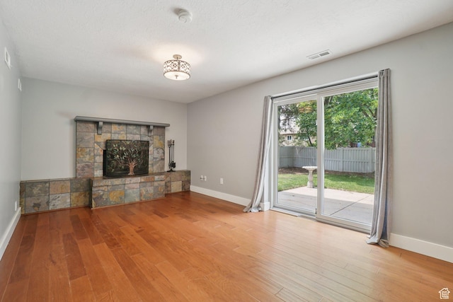 8892 S Flatiron Dr, Sandy, UT 84093 - unfurnished living room with wood finished floors and a fireplace
