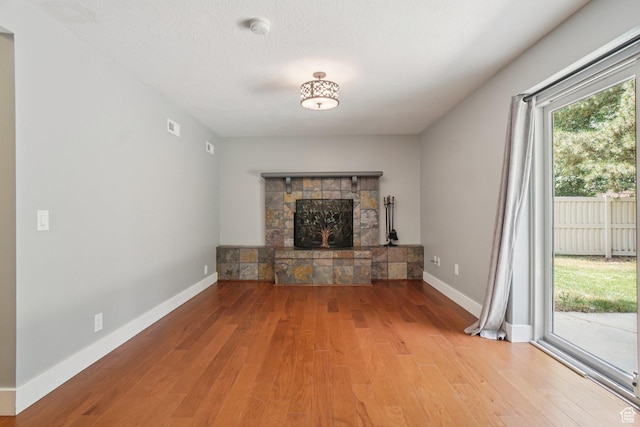 8892 S Flatiron Dr, Sandy, UT 84093 - unfurnished living room with wood finished floors and a fireplace