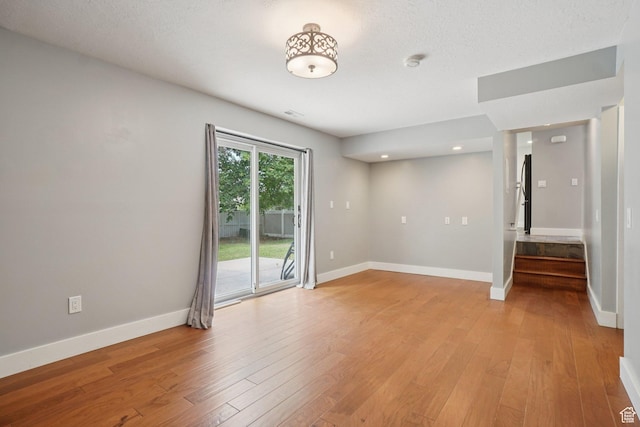 8892 S Flatiron Dr, Sandy, UT 84093 - unfurnished room with a smoke detector, light wood finished floors, stairs, and recessed lighting