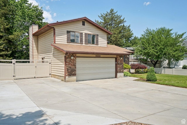8892 S Flatiron Dr, Sandy, UT 84093 - view of front facade featuring an attached garage, concrete driveway, a gate, a chimney, and brick siding