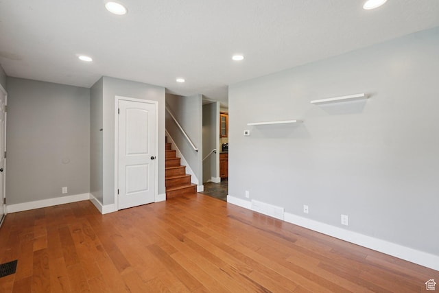 8892 S Flatiron Dr, Sandy, UT 84093 - unfurnished room with stairway, recessed lighting, and wood finished floors